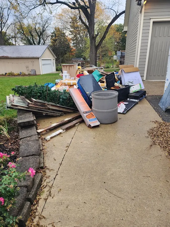 Dumpster being loaded with debris for 12 Yard Dumpster Rental in Calera
